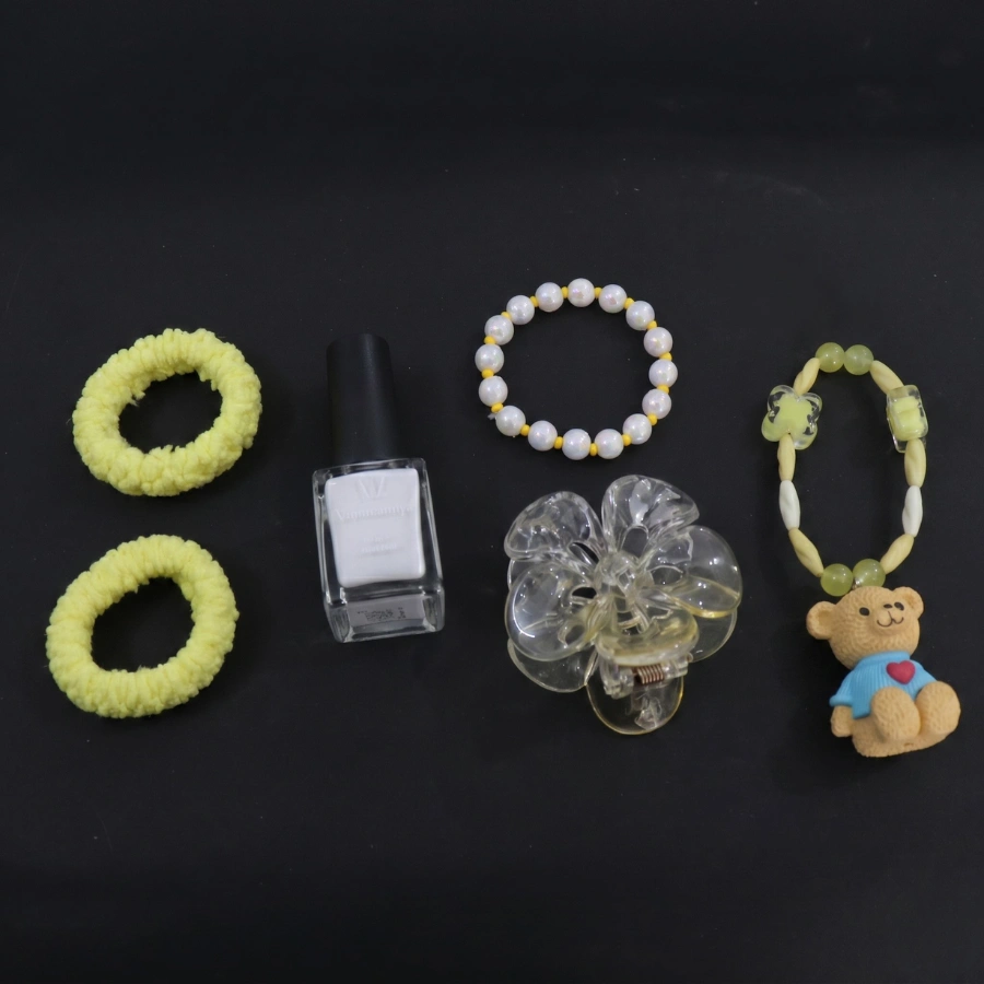 Beauty Essentials & Hair Accessories Kit with Bracelet and Nail Polish Add charm and elegance to your everyday look with this stylish Women's Fashion & Beauty Accessories Gift Set. This thoughtfully curated 5-piece collection includes soft hair bands, a classic pearl bracelet, premium nail polish, a transparent flower-shaped hair claw clip, and a cute teddy charm bracelet. Designed for women, girls, and teens, this versatile accessory set combines beauty essentials with fashionable accessories that complement both casual and special occasion outfits. The comfortable hair ties help create effortless hairstyles, while the pearl bracelet and teddy charm bracelet add a playful yet elegant touch. Complete your look with the trendy nail polish and stylish flower hair claw clip. Beauty Essentials & Hair Accessories Kit with Bracelet and Nail Polish